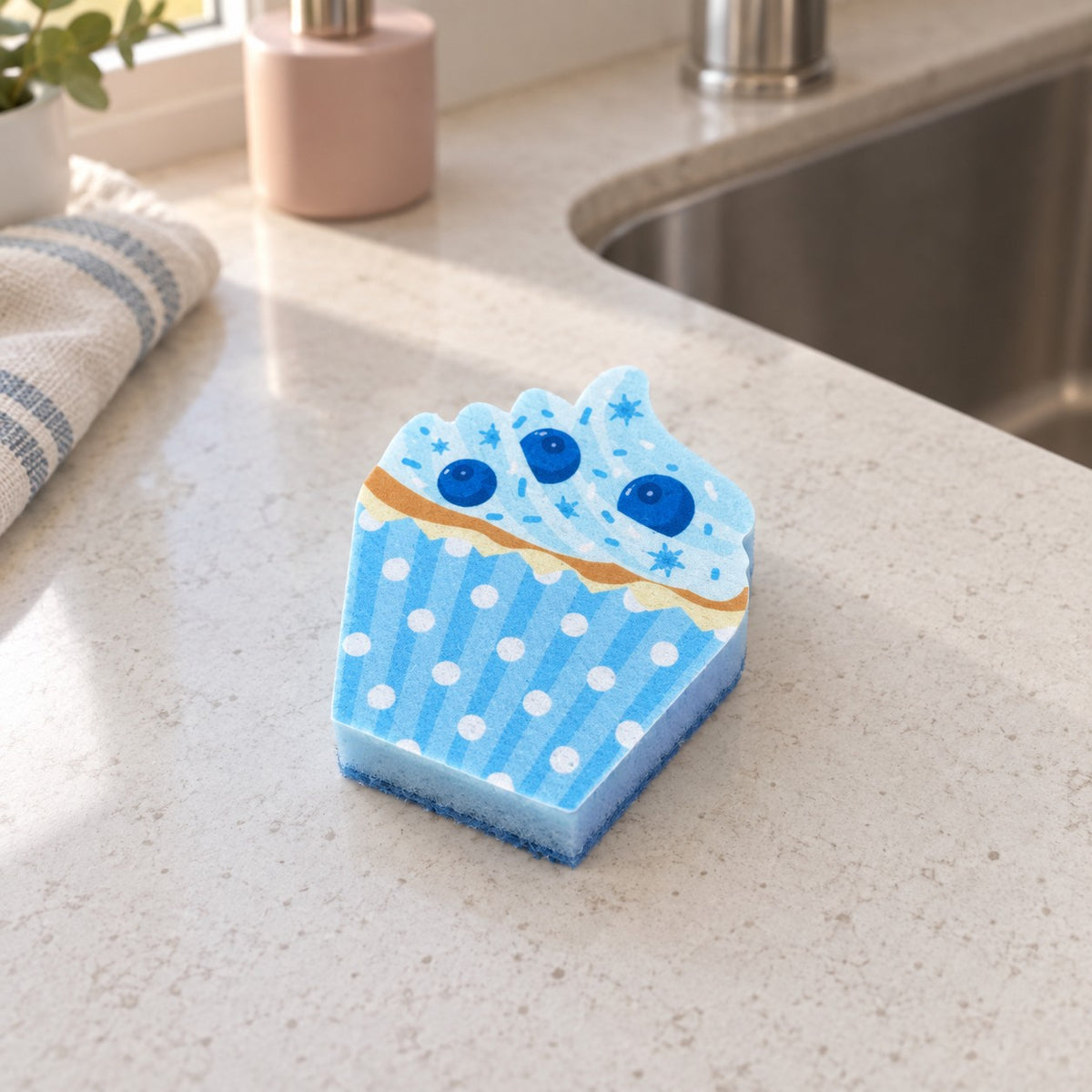 Blue cupcake kitchen sponge with flat blueberry artwork, blue stripes and white dots.